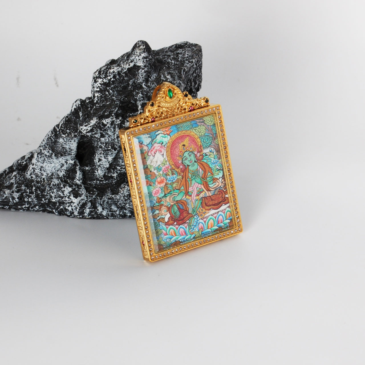 Side detail of Green Tara mini thangka pendant highlighting double-sided construction, metal casing edges, and refined hand-painted Nepalese thangka artwork