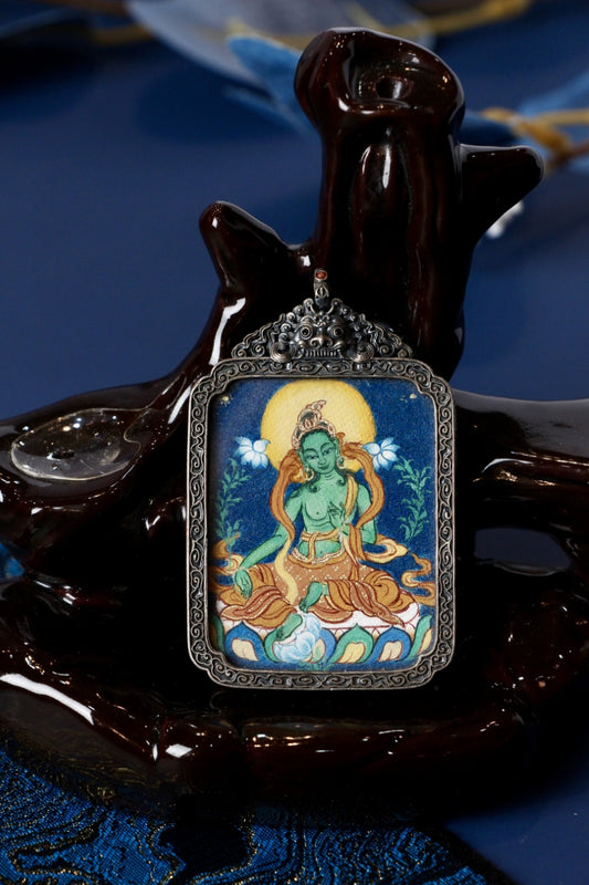 Close-up of a Green Tara mini thangka pendant, Tibetan mineral pigments, set in an ornate vintage silver gawu locket