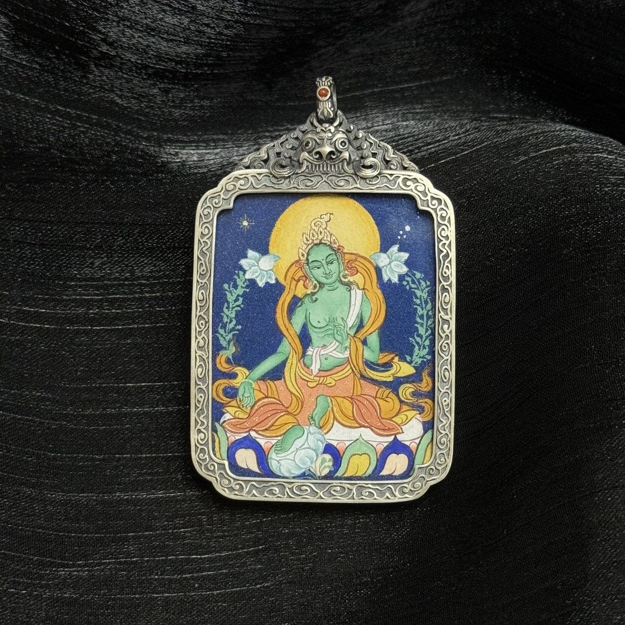 Hand-painted Green Tara mini thangka pendant featuring dense mineral pigments, Tibetan iconography, and a vintage-style silver protective case.