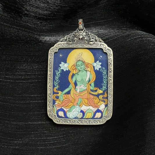 Hand-painted Green Tara mini thangka pendant featuring dense mineral pigments, Tibetan iconography, and a vintage-style silver protective case.