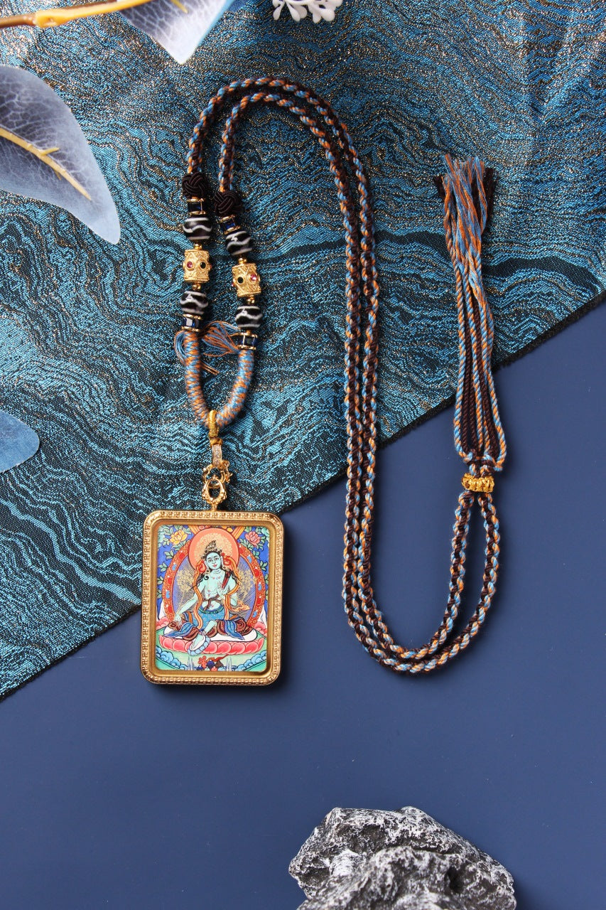 Portable Green Tara thangka necklace with braided cord, hand-painted by Tibetan lama artist using natural mineral pigments, suitable for daily wear or travel.