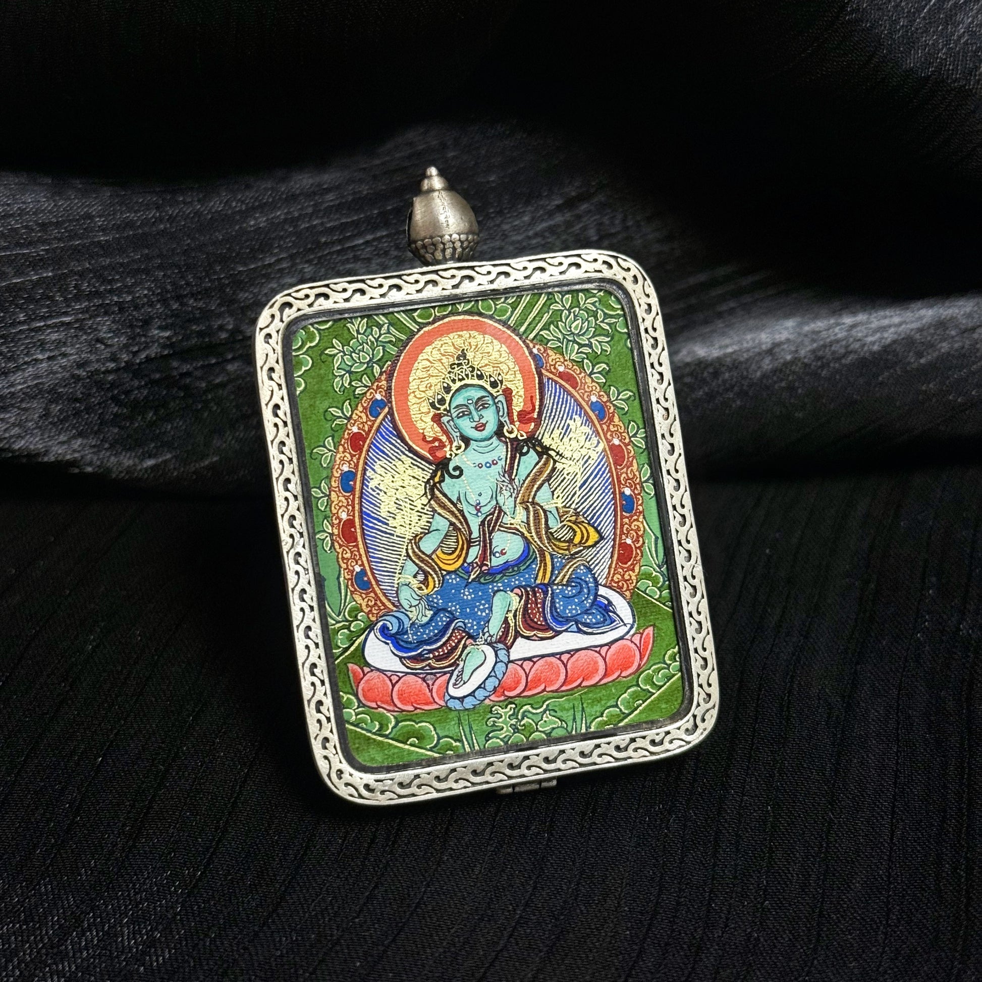 Close view of Green Tara mini thangka pendant highlighting detailed Tibetan hand-painted thangka artwork and 925 silver pendant frame