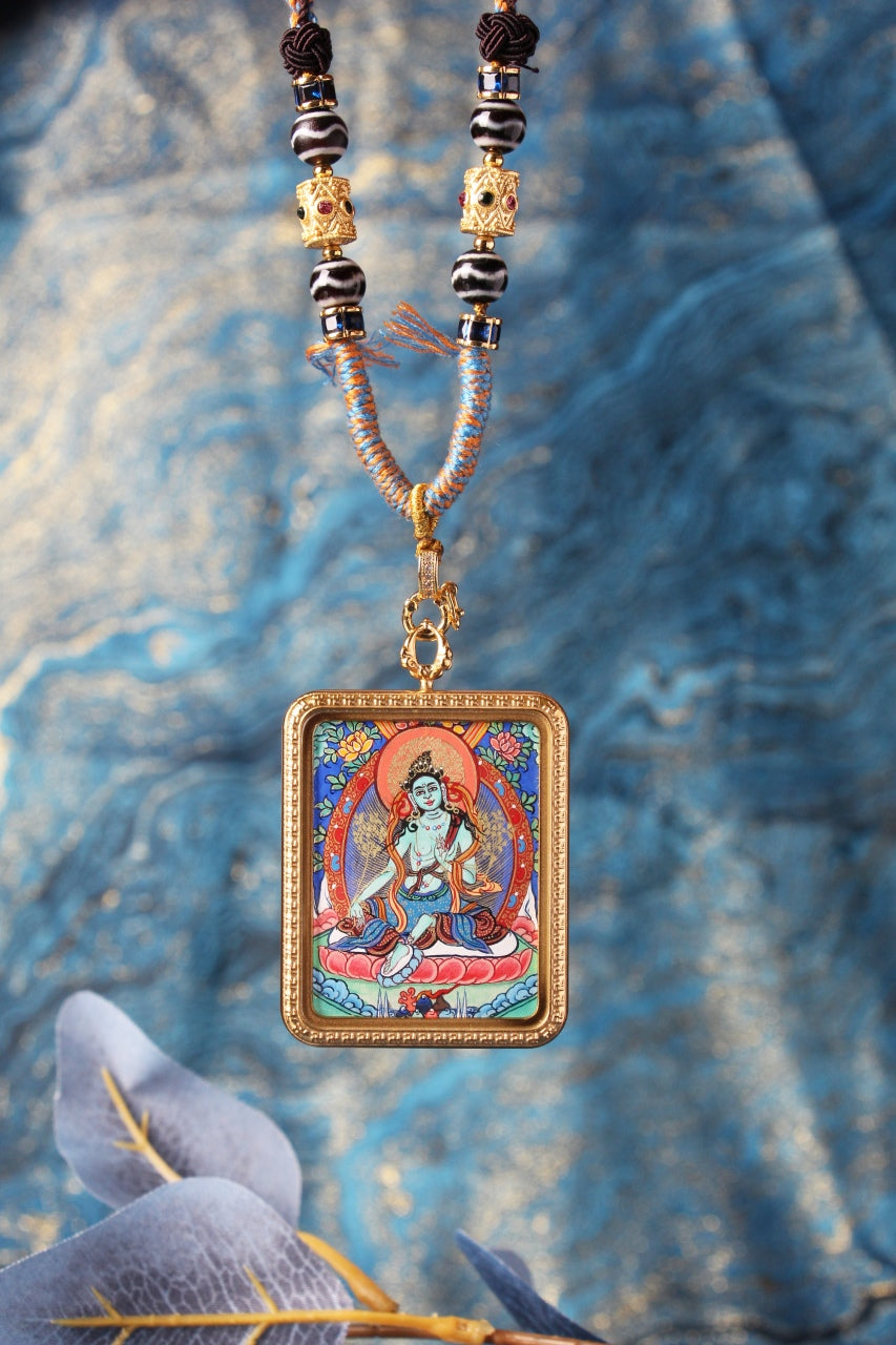 Close-up of Green Tara thangka painting showing traditional Tibetan iconography, symbolizing compassion, protection, longevity, and wisdom.