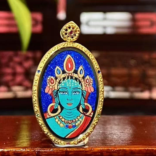 Front view of a double-sided Green Tara Thangka pendant, hand-painted with 18K gold in Rebgong tradition, depicting Green Tara as a symbol of compassion and wisdom.
