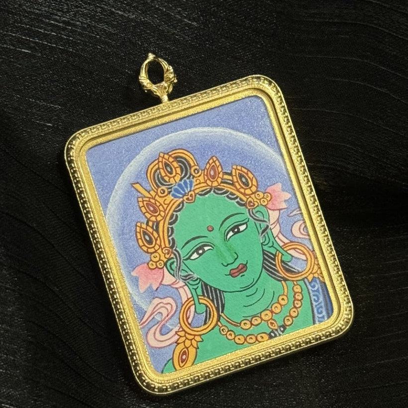 Close-up detail of a Green Tara Buddha head thangka pendant, Newar Buddhist art hand-painted and protected in a durable titanium steel case