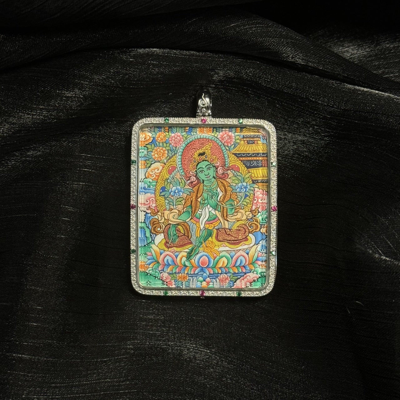 Hand-painted Tibetan Green Tara miniature thangka pendant featuring the bodhisattva with lotus flowers, halo, and vibrant mineral pigment colors.