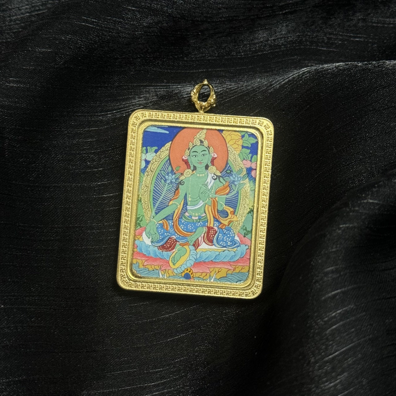 Green Tara Tibetan thangka pendant showing detailed hand painted Buddhist iconography, miniature portable thangka artwork from Tibet.