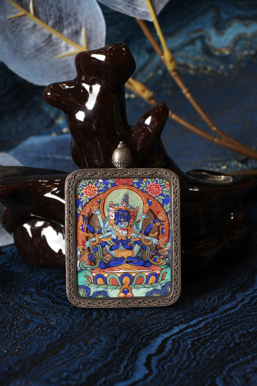 Front view of a Guhyasamāja Vajra mini thangka pendant from Rebgong, fully hand-painted by a lama artist with natural mineral pigments, set in a Dunhuang Nine-Colored Deer pure silver case.