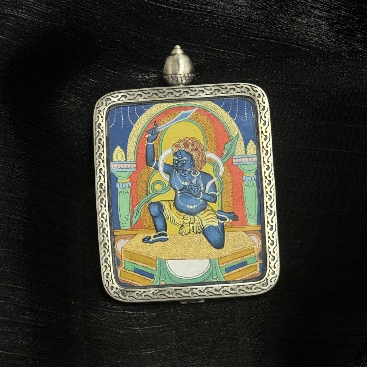 Hand-painted 4×5 cm Acalanatha (Fudo Myo-o) mini Thangka pendant displayed on dark fabric background
