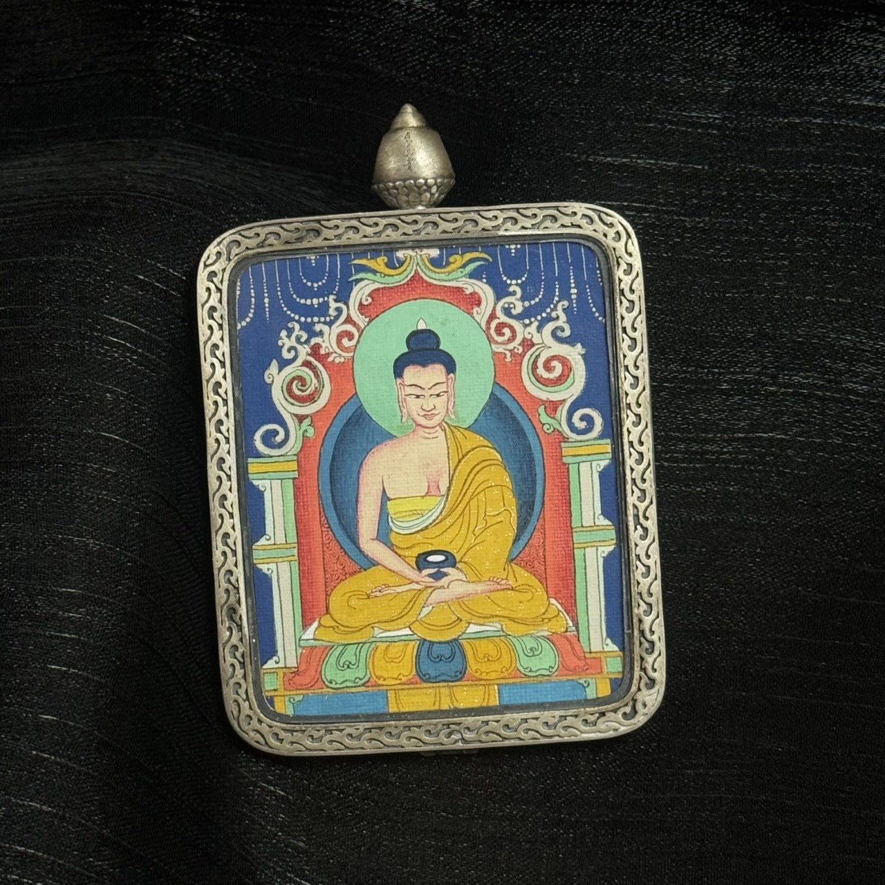 Hand-painted 4×5 cm Amitabha Buddha mini Thangka pendant displayed against dark fabric background