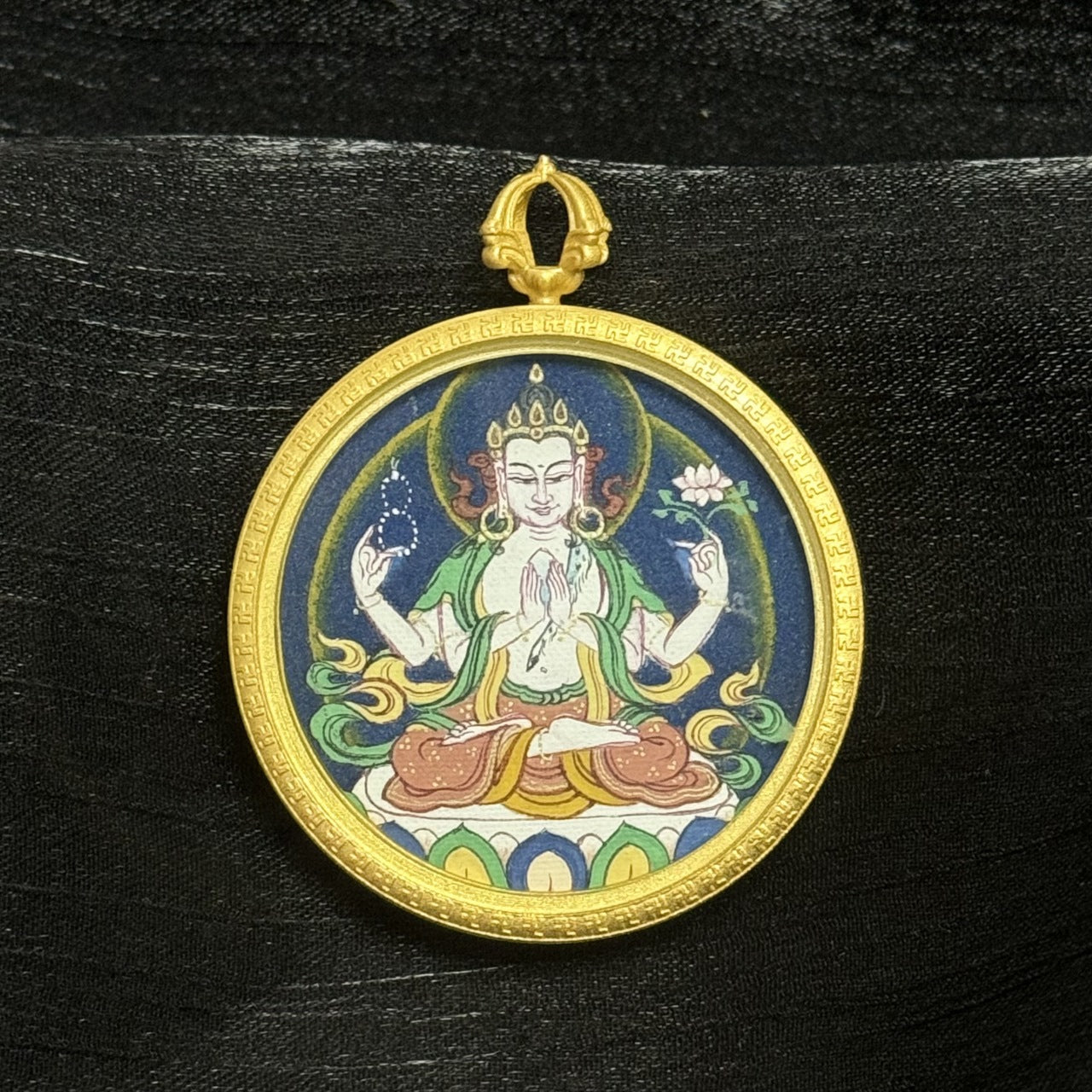 Detailed view of the hand-painted Four-Armed Avalokiteshvara mini thangka, highlighting traditional Tibetan painting style and mineral pigment texture
