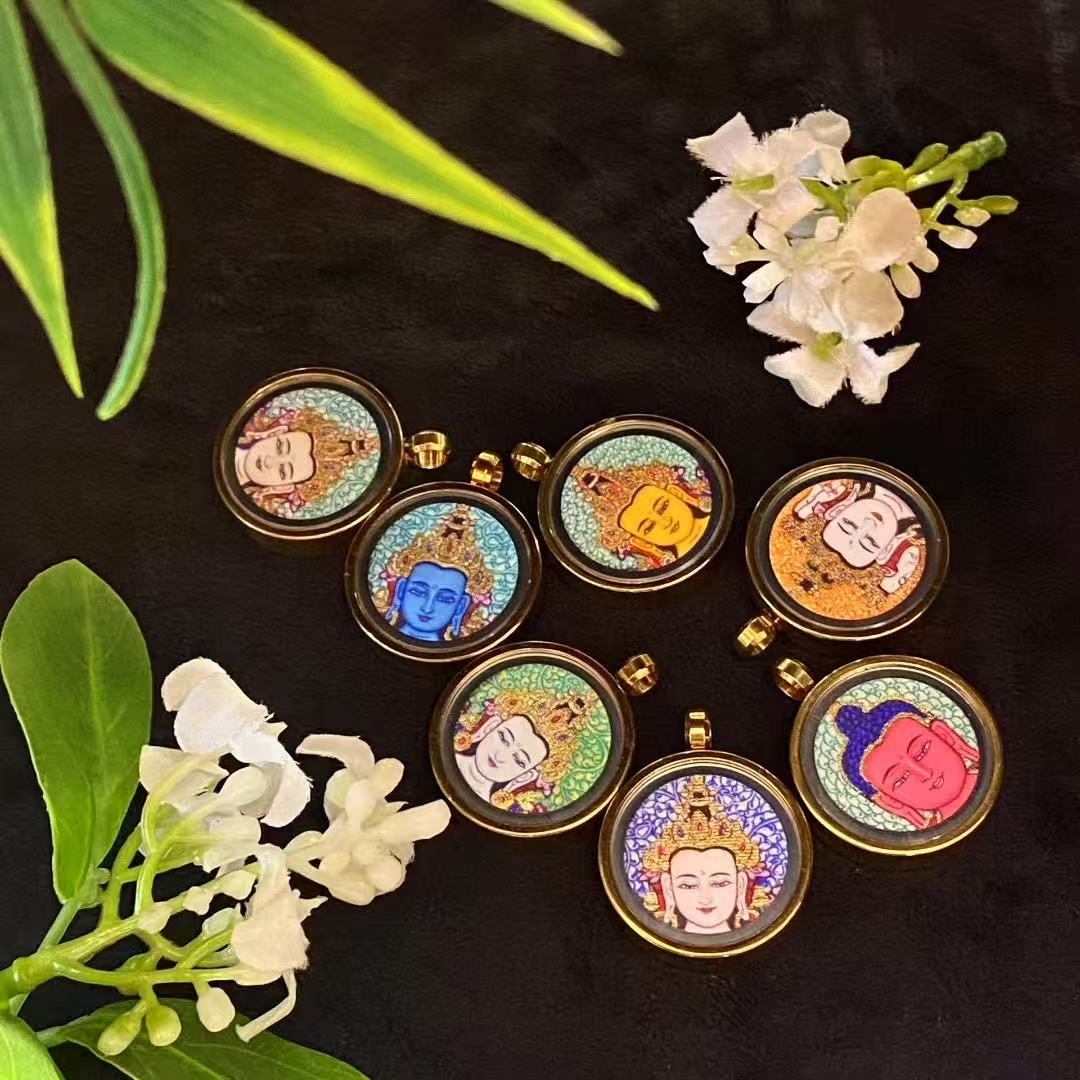 Hand-painted gold-outlined Tibetan thangka pendant in round titanium steel gau box, 29mm diameter