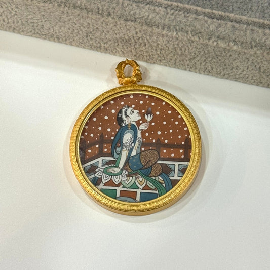 Front view of a hand-painted Holding Lotus Avalokiteshvara mini thangka pendant, painted with mineral pigments and set in a round matte copper case with decorative rim.