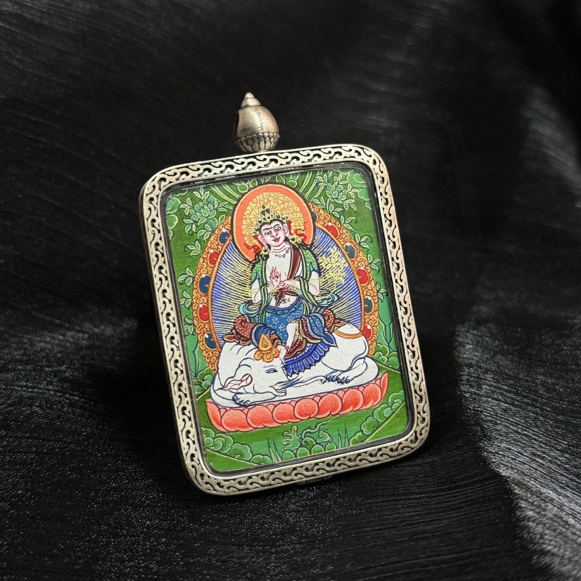 Close view of Samantabhadra Bodhisattva mini thangka pendant showing mineral pigment colors and traditional Tibetan thangka iconography