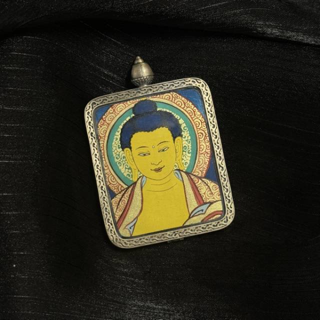 Front view of Shakyamuni Buddha mini thangka pendant featuring traditional Buddhist iconography painted with mineral pigments