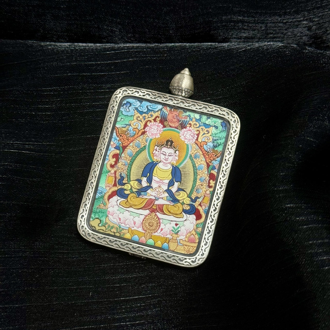 Close perspective of Vairocana Buddha mini thangka, traditional Menri style composition with halo, lotus base, and intricate mineral pigment detailing.