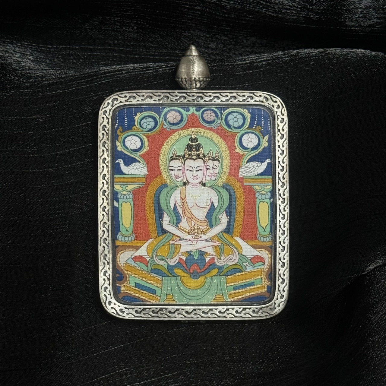 Hand-painted 4×5 cm Vairocana Buddha mini Thangka pendant displayed against dark fabric background