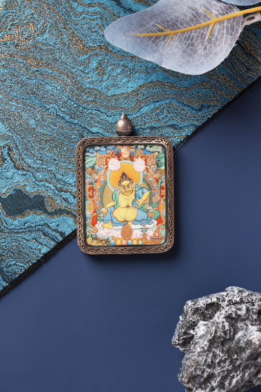 Hand-painted Yellow Jambhala thangka pendant from Tibet, Menri school style, traditional Buddhist art for wealth blessing and spiritual practice