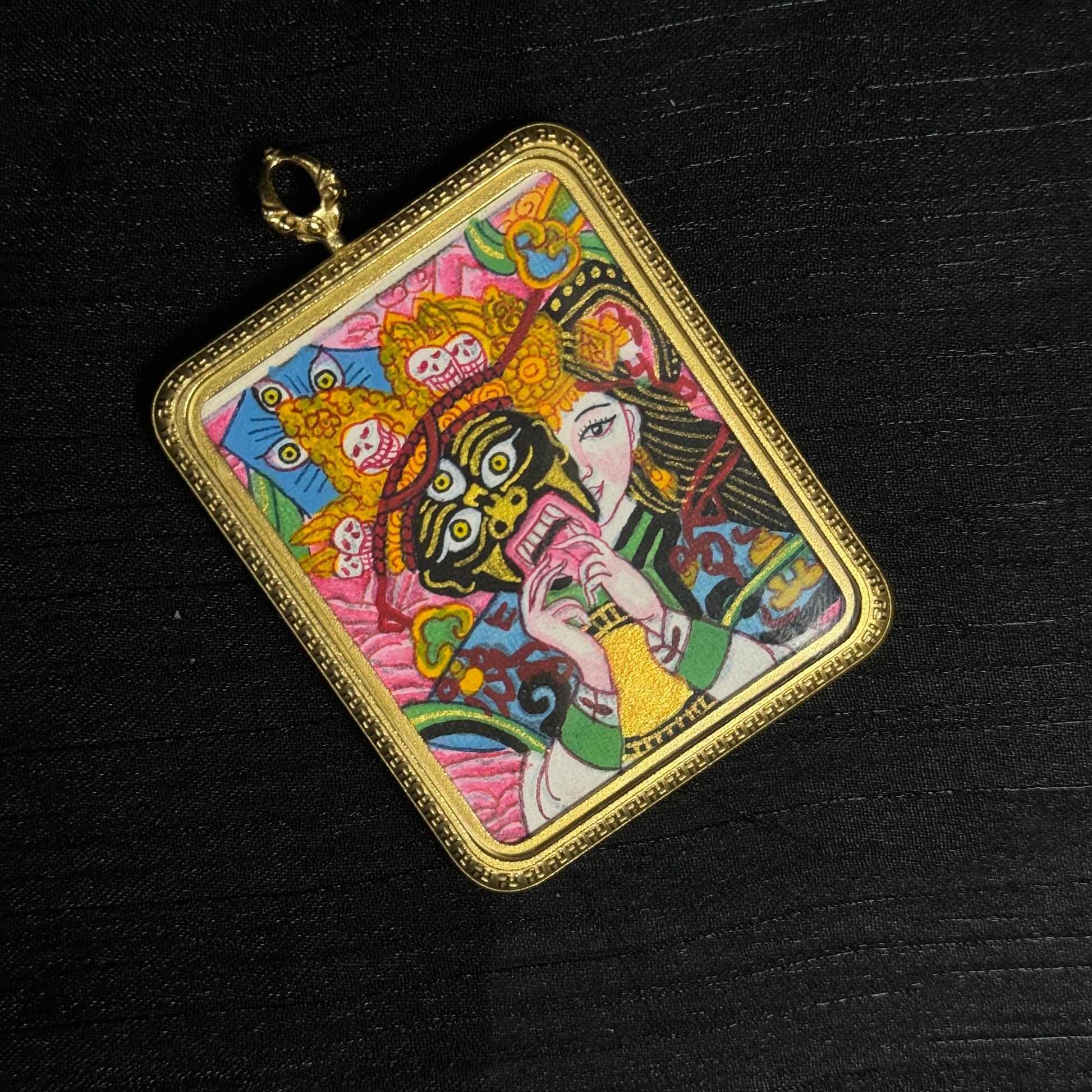 Detailed view of hand-painted Zaki Lhamo miniature thangka pendant with colorful deity composition and traditional Nepalese thangka style.