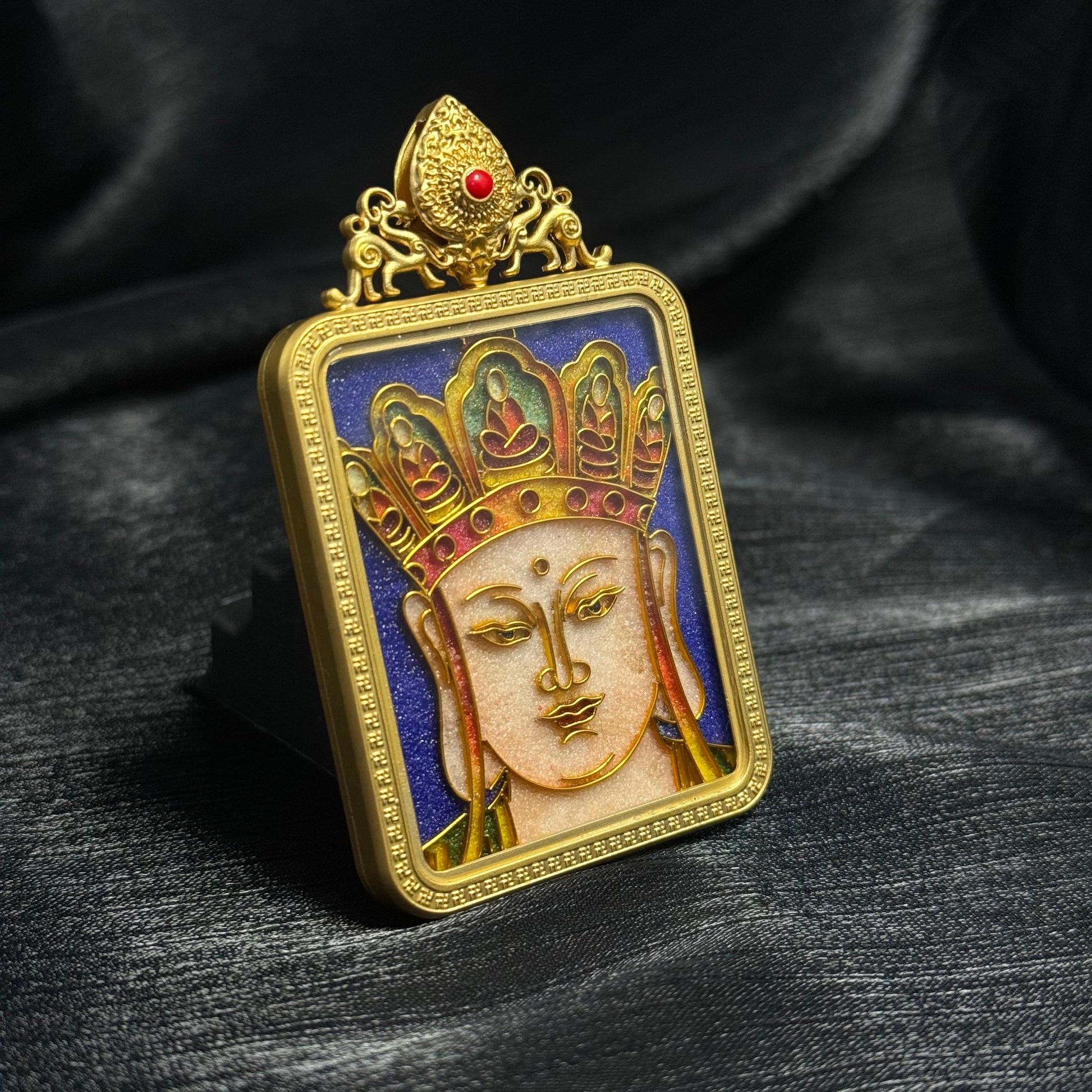 Detailed view of handcrafted Ksitigarbha Bodhisattva cloisonné enamel mini thangka pendant highlighting bodhisattva crown details, layered enamel colors, and decorative gold frame