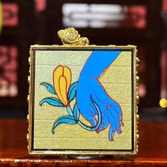 Back view of double-sided Tibetan mini thangka pendant featuring Haritaki fruit symbolism associated with Medicine Buddha tradition