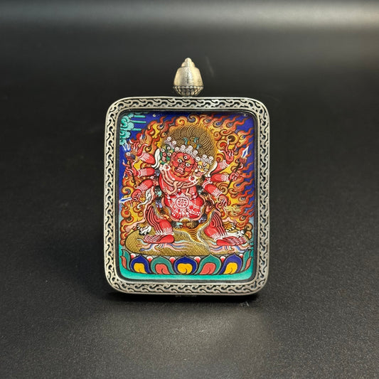 Front view of Hayagriva mini thangka pendant showing the wrathful horse-headed deity surrounded by flames, hand-painted with natural mineral pigments in the Rebgong thangka tradition and set in a carved sterling silver pendant frame.