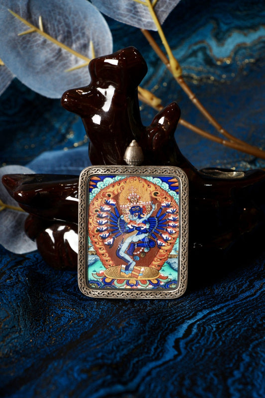 Front view of a Hevajra mini thangka pendant, fully hand-painted by a lama artist with natural mineral pigments in the Rebgong Tibetan style, set in a Dunhuang Nine-Colored Deer pure silver case.
