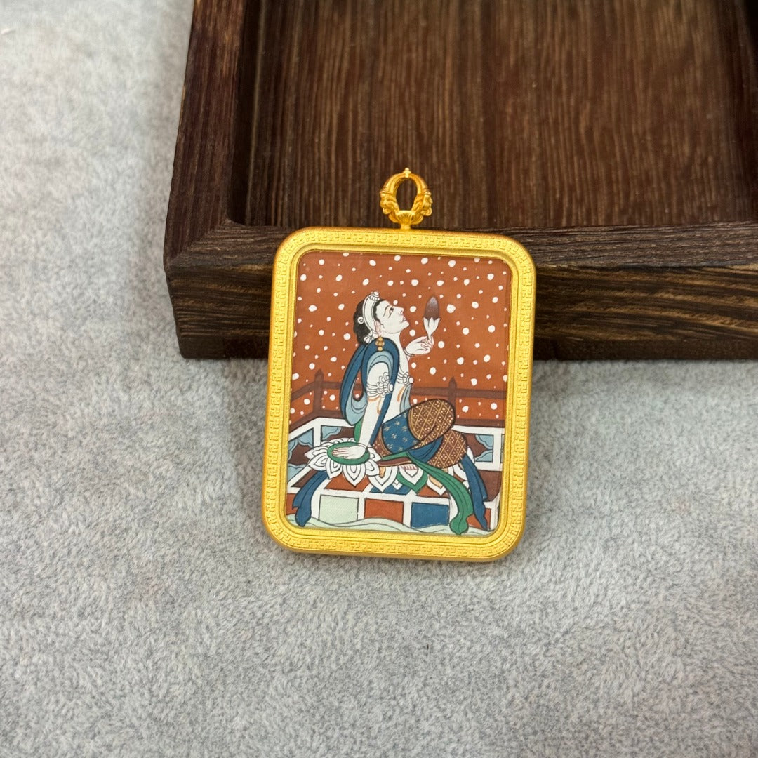 Upright display of a Holding Lotus Avalokiteshvara mini thangka pendant, highlighting delicate line work, layered mineral pigments, and balanced Dunhuang-inspired composition.
