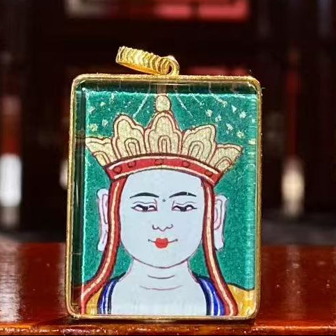 Front view of a Kṣitigarbha Bodhisattva Buddha Head Thangka pendant, double-sided and hand-painted in 18K gold using traditional Rebgong craftsmanship