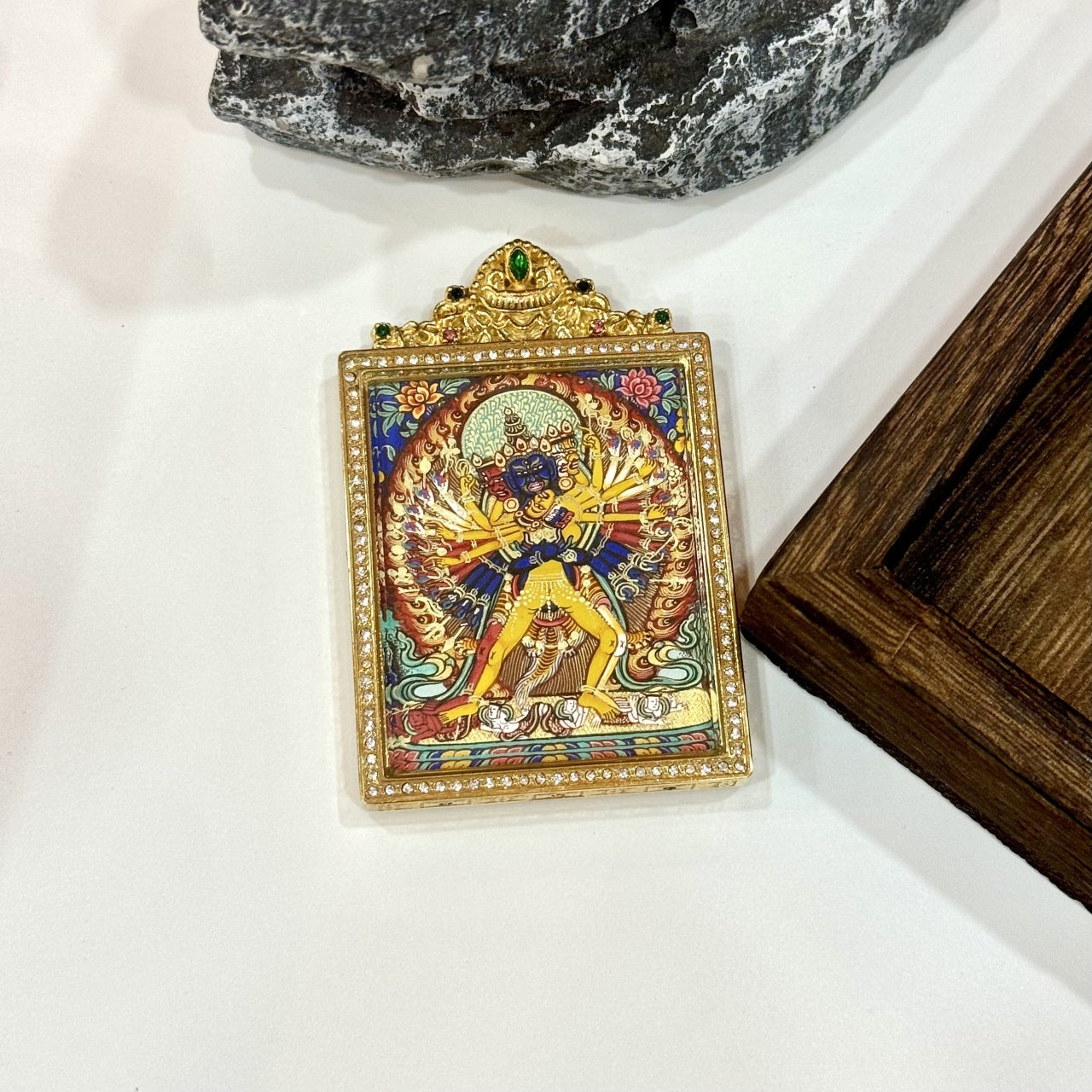 Front view of Kalachakra mini thangka pendant, hand-painted with mineral pigments, featuring complex tantric iconography and housed in a double-sided jewelry-grade titanium steel case.