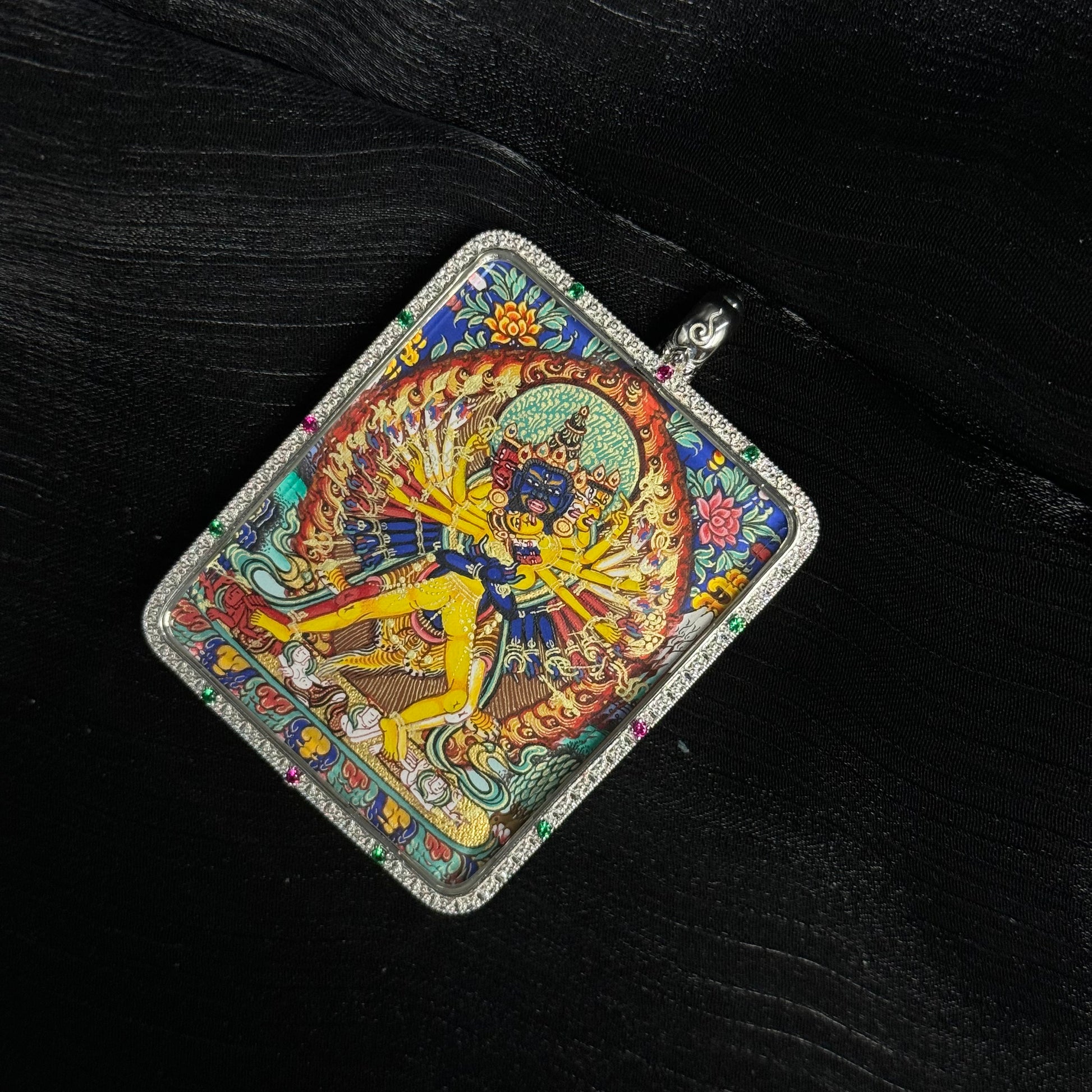 Detailed view of Kalachakra deity painting in mini thangka pendant with vibrant mineral pigments and traditional Tibetan iconography