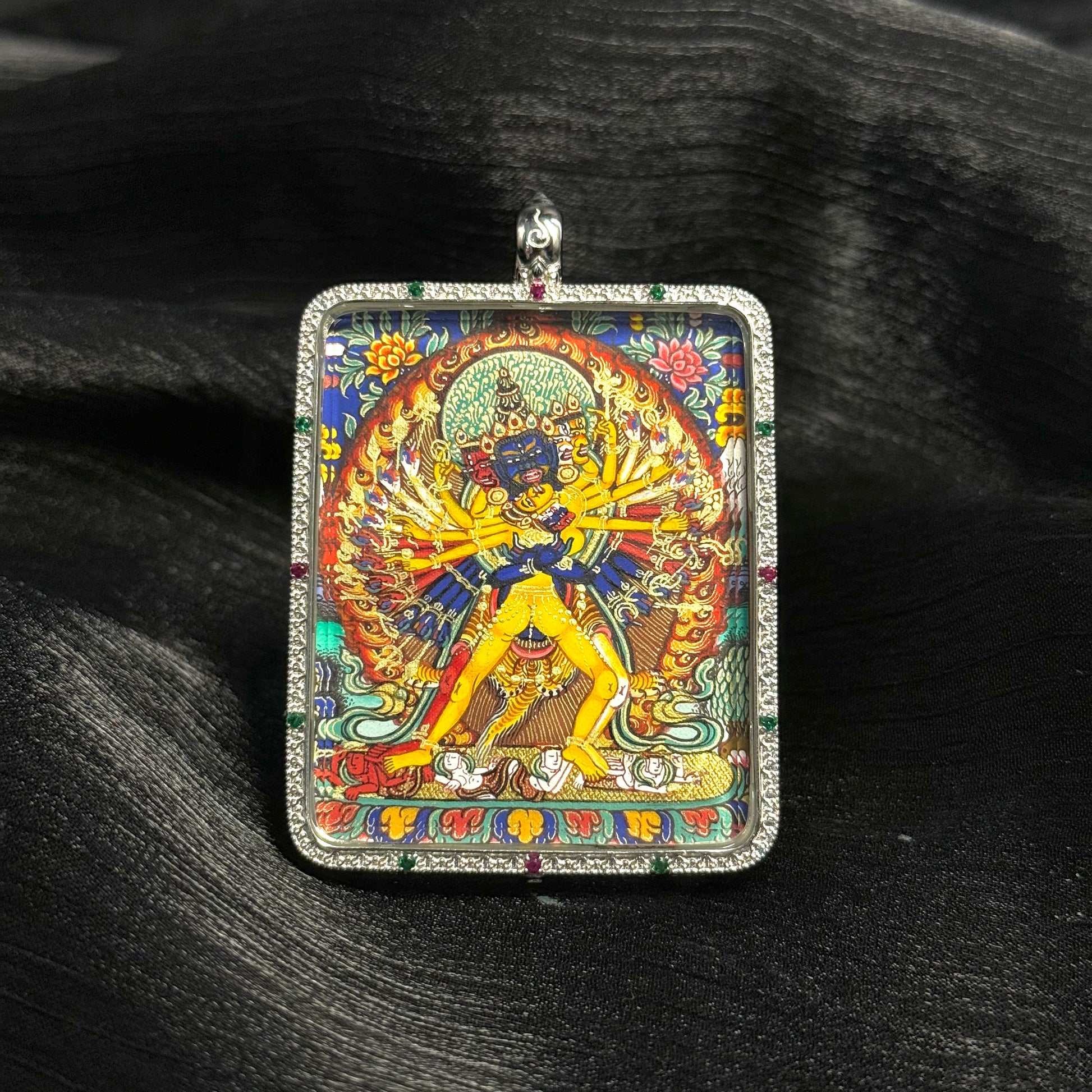 Close view of Kalachakra mini thangka pendant showing intricate hand-painted Rebgong thangka artwork and jeweled silver frame