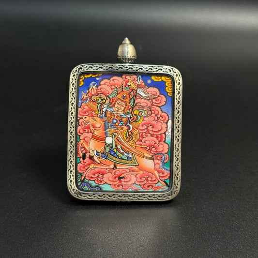Front view of King Gesar mini thangka pendant featuring the Tibetan warrior king riding a horse, hand-painted with natural mineral pigments in Rebgong style and mounted in a carved sterling silver pendant frame.
