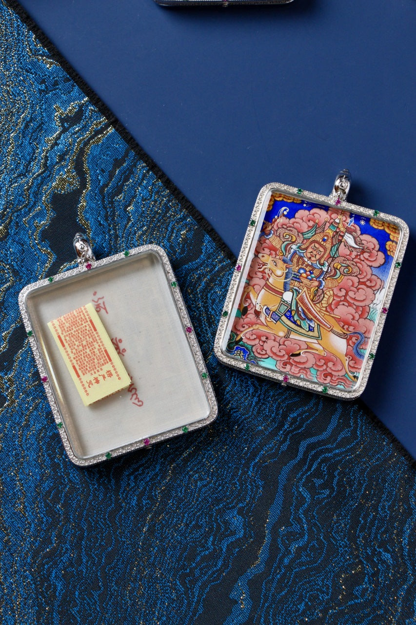 Open 925 silver gawu pendant box showing the inner compartment and King Gesar hand-painted mini thangka panel on blue brocade background.