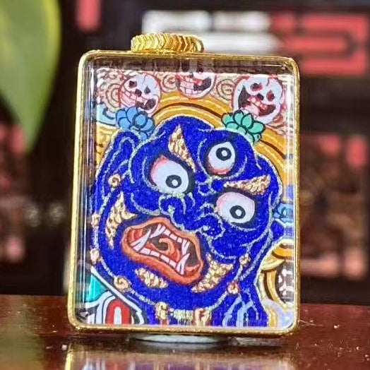 Front view of Mahakala thangka pendant hand-painted in 18K gold, Rebgong style protector deity holding skull cup and chopper