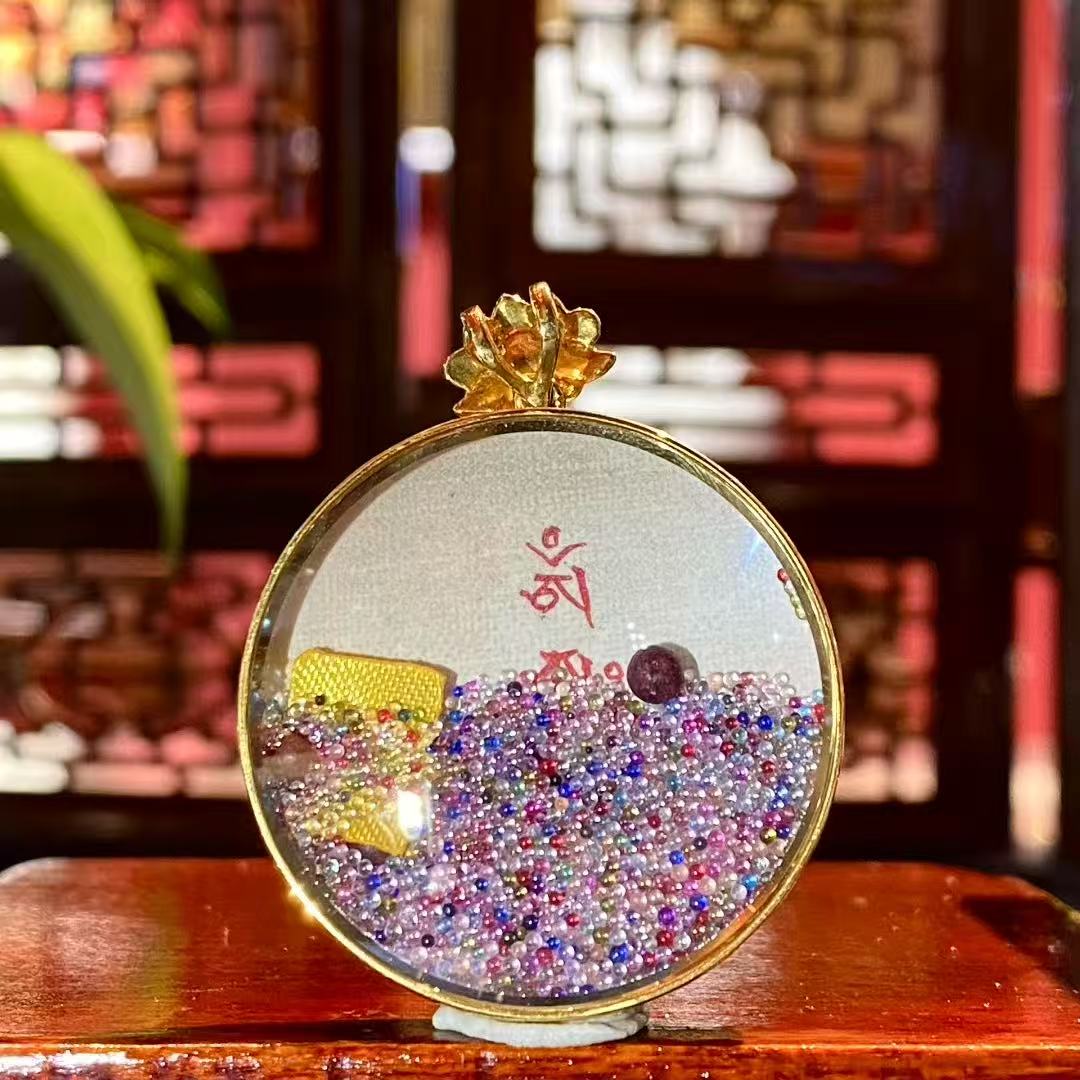 Back view of Mahakala Gau pendant with hand-painted Seven Treasures glass bead Hada motif, 18K gold Tibetan artwork
