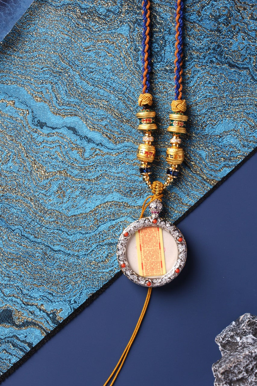 Back view of a Mahakala mini thangka pendant showing the inner scripture insert and decorative copper case, highlighting the pendant’s double-layer structure.