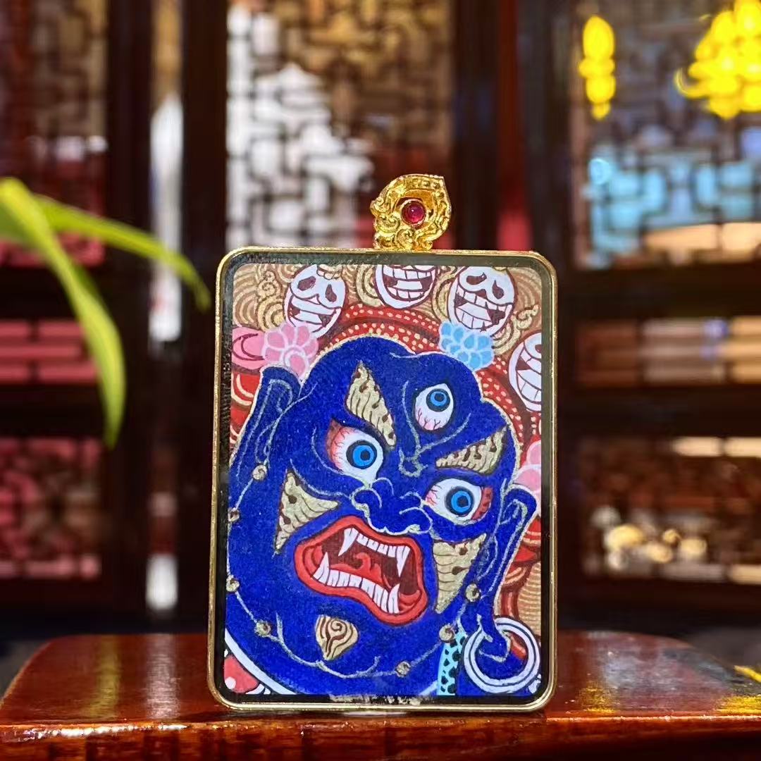 Back view of a double-sided Mahakala Thangka pendant, fully hand-painted with 18K gold, portraying Mahakala as a fierce protector deity in Rebgong tradition.
