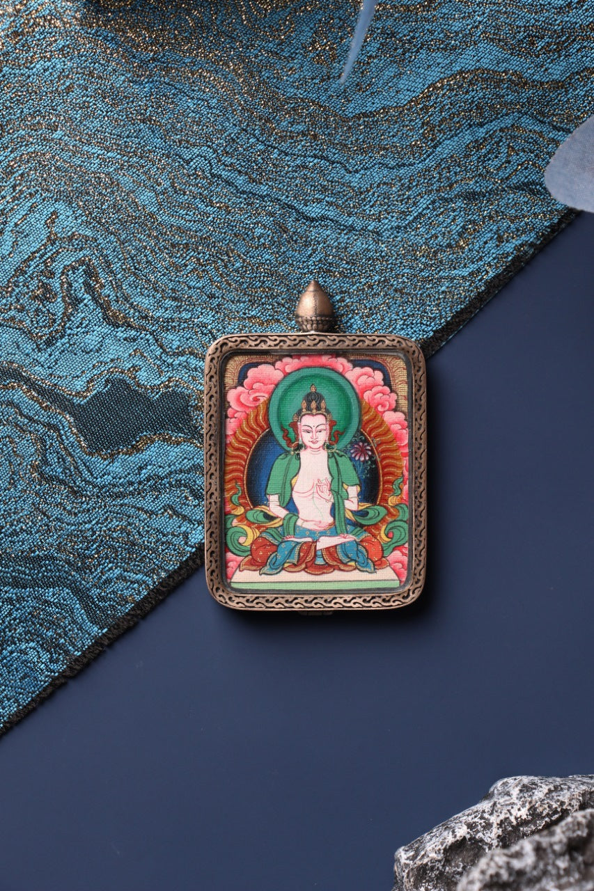 Close-up view of the hand-painted Mahasthamaprapta Bodhisattva mini thangka pendant, showing detailed mineral pigment colors and traditional Tibetan iconography