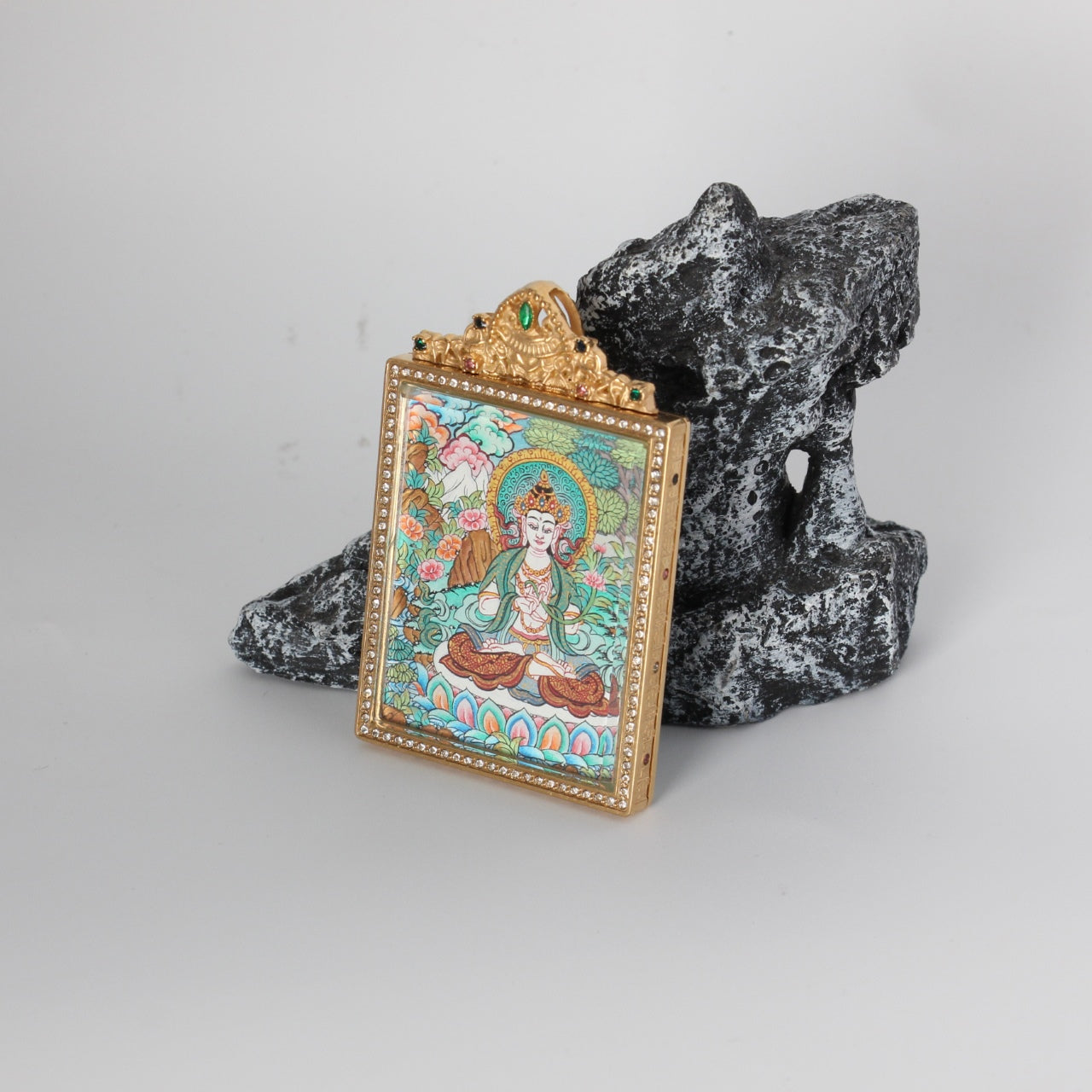 Side angle display of a Nepal hand-painted Mahasthamaprapta Bodhisattva mini thangka pendant in a double-sided jewelry-grade titanium steel case.