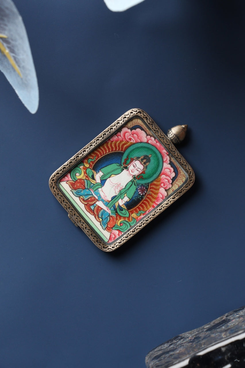 Front view of Mahasthamaprapta Bodhisattva mini thangka pendant, hand-painted with natural mineral pigments and set in a Tibetan silver gawu-style case