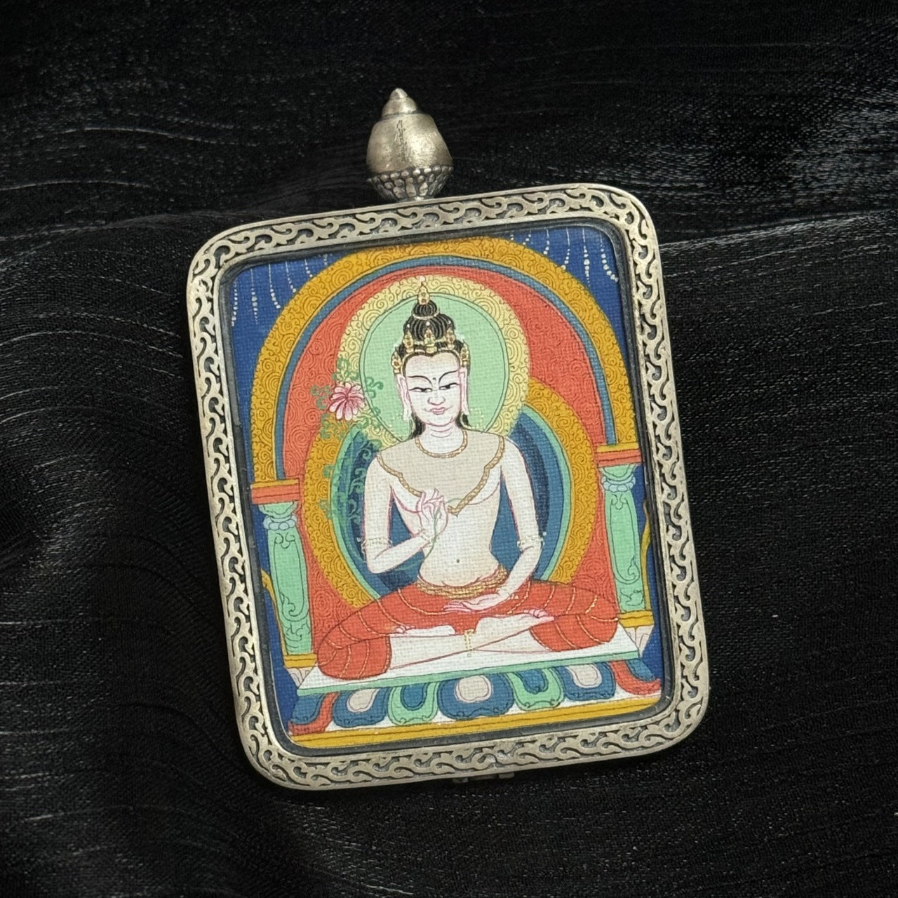 Portable Mahasthamaprapta Bodhisattva mini thangka pendant in decorative silver frame, Tibetan Buddhist sacred painting suitable for meditation or altar.