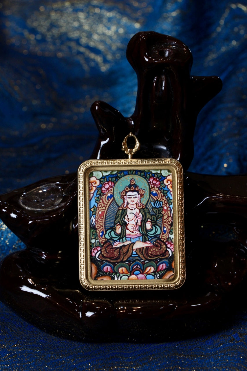 Close-up of a Mahasthamaprapta Bodhisattva (Mahāsthāmaprāpta) hand-painted Nepal thangka pendant in a gold-tone frame on a black display stand.