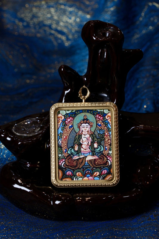 Close-up of a Mahasthamaprapta Bodhisattva (Mahāsthāmaprāpta) hand-painted Nepal thangka pendant in a gold-tone frame on a black display stand.
