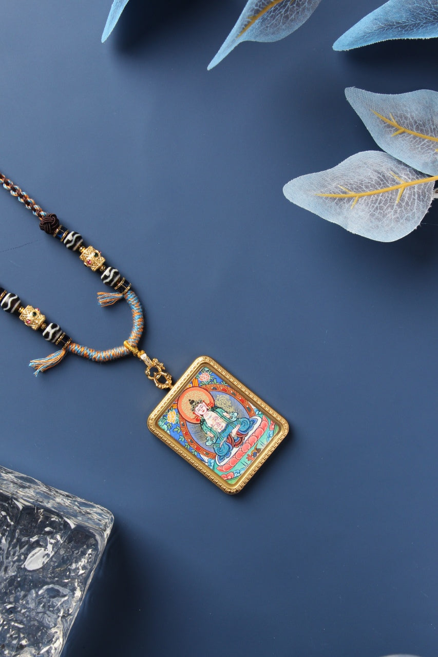 Full set of Mahasthamaprapta Bodhisattva pendant necklace showing the titanium steel case, hand-painted thangka insert, braided cord, decorative beads, and adjustable long necklace rope.
