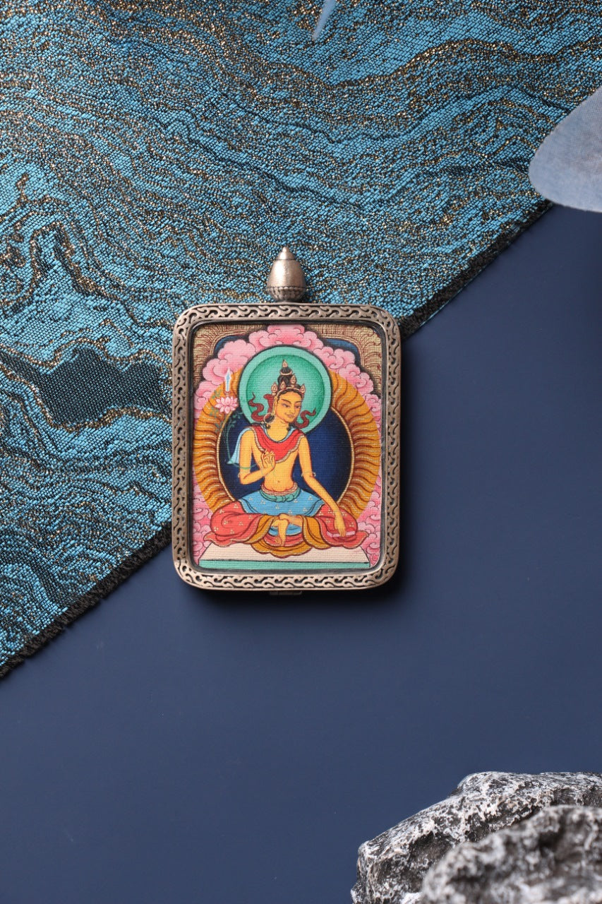 Close-up view of the hand-painted Manjushri Bodhisattva mini thangka pendant, showing detailed mineral pigment colors and traditional Tibetan iconography