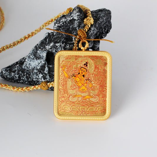 Front view of a Manjushri Bodhisattva mini thangka pendant featuring a gold-ground composition, fine red linework, and an orange-toned deity figure, hand-painted with mineral pigments and housed in a copper case.