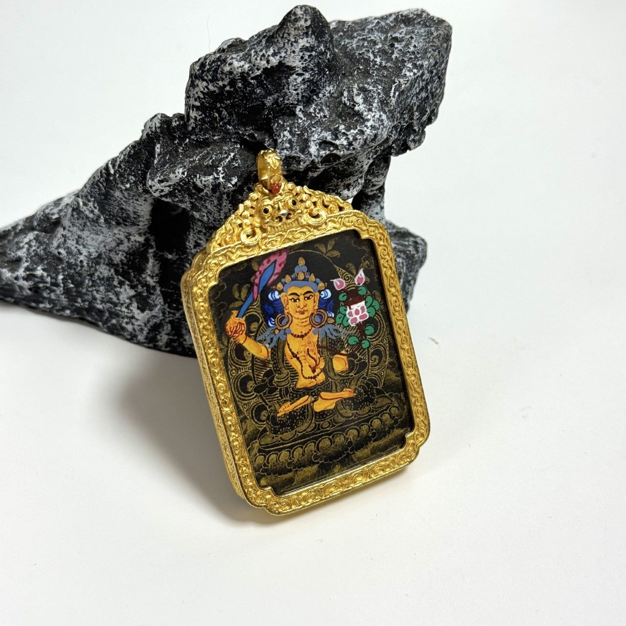 Full view of Manjushri Bodhisattva mini thangka pendant highlighting gold-accented copper frame, black gold painting surface, and compact pendant format