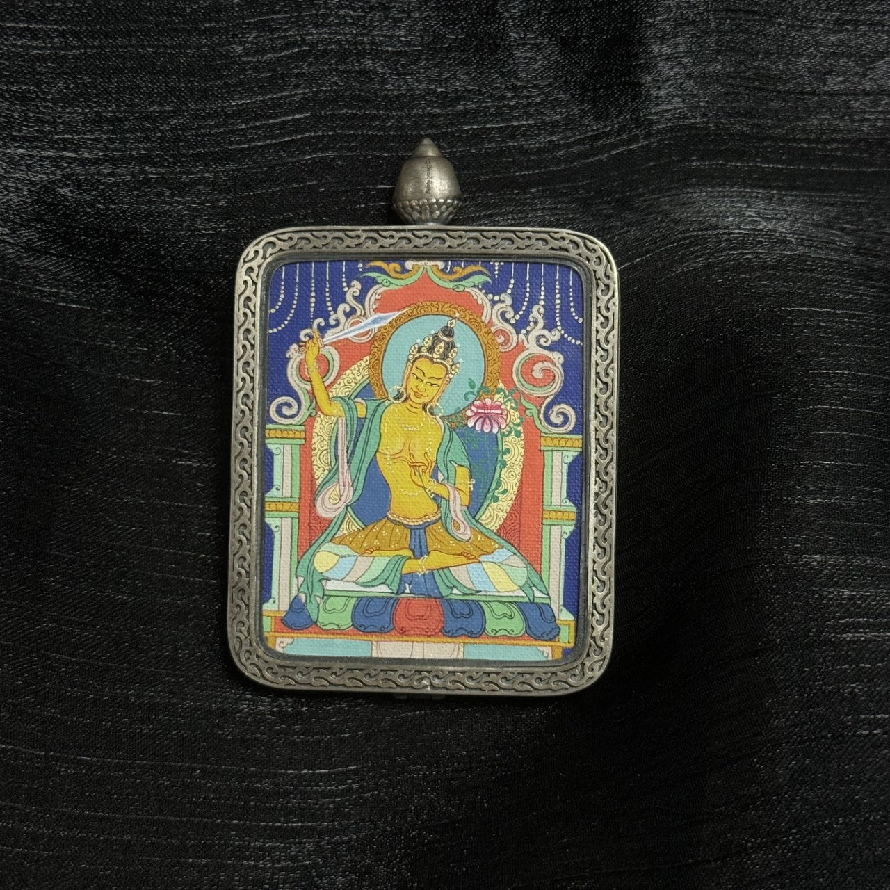 Hand-painted Manjushri Bodhisattva mini thangka in Qigang painting style, featuring wisdom sword and lotus iconography inside an engraved Dunhuang Nine-Color Deer silver gawu pendant frame