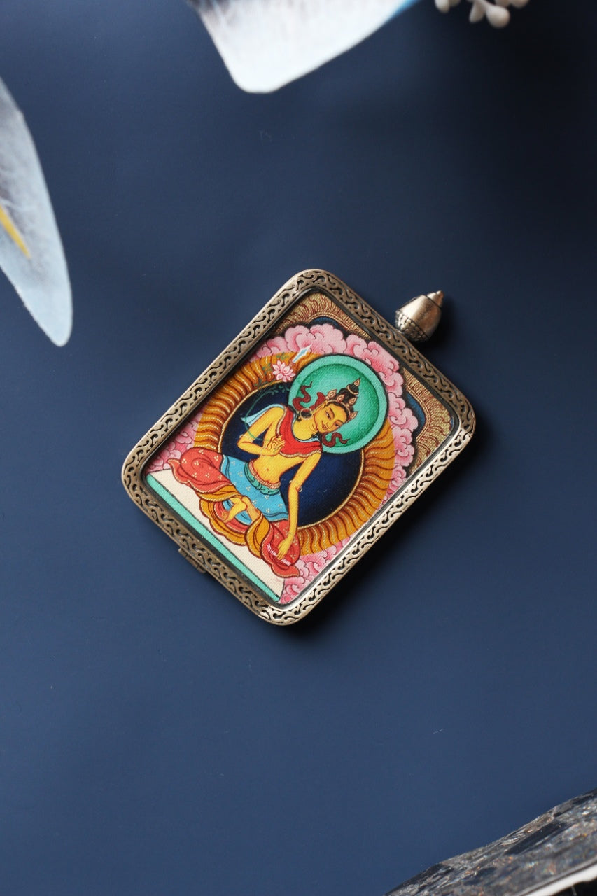Front view of Manjushri Bodhisattva mini thangka pendant, hand-painted with natural mineral pigments and set in a Tibetan silver gawu-style case